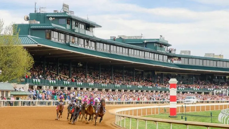 Horses round a turn at Keeneland Racetrack