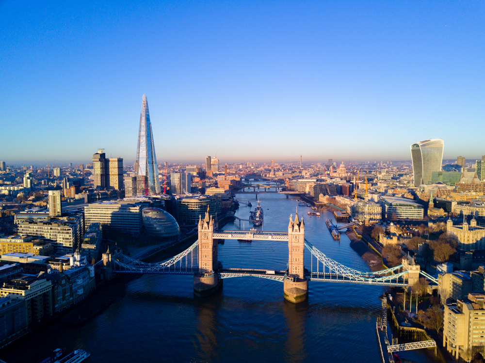 Aerial view over Tower Bridge, River Thames and the city of London, UK